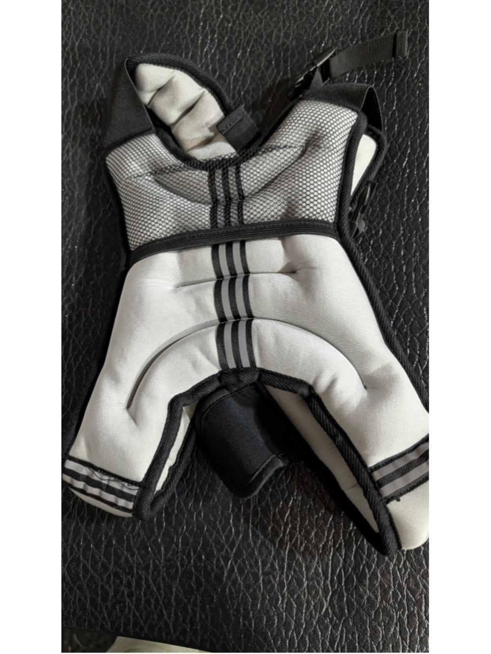 grey and black weighted fitness vest with mesh panels and reflective stripes